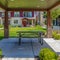 Square Patio on a lawn surrounded by houses under blue sky