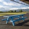 Square Picnic area with spool tables and blue wooden tables under a pavilion