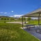 Square Picnic pavilion with a pathway connected to a water park near a building