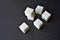 Square pieces of refined sugar on a black background