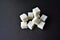 Square pieces of refined sugar on a black background