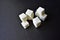 Square pieces of refined sugar on a black background