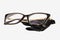 Square plastic oversized eyeglasses frames for women and black microfiber cleaning cloth isolated on a white background