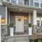 Square Porch and yard at the facade of a home with stairs leading to the front door