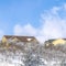 Square Pristine terrain of Wasatch Mountains with homes amidst fresh snow in winter