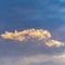 Square Puffy clouds illuminated by sunlight in the boundless blue sky