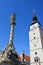 Square renaissance city tower of Trnava with typical sundial, balcony and clockwork, in late spring daylight sunshine.