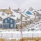 Square Residential area with colorful homes against cloudy sky in winter
