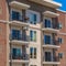 Square Residential building exterior with vivid blue sky background on a sunny day