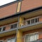 Square Residential building with flat roof balconies and red brick exterior wall