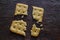 Square saltine cracker is broken into four random pieces