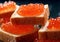 Square sandwiches with red salmon trout caviar on black.Macro.Ai Generative