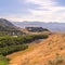 Square Scenic mountain landscape with houses amidst vast slopes covered with greenery