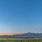 Square Scenic panoramic view of the valley lake and snow peaked mountain under blue sky