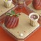 Square shape cup dessert with strawberry and brown whipped cream on a red background