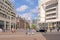 Square with shops, apartment buildings and skyscrapers in The Hague