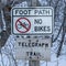 Square Signages by a foot path trail at Wasatch Mountains blanketed with snow in winter