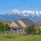 Square Single storey houses against striking snow capped mountain and vibrant blue sky