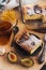 A square slice of plum pie on a round black antique plate, acacia honey, a vintage teaspoon