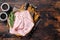 Square Sliced pork meat ham on plate. Wooden background. Top view. Copy space