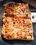 Square slices of delicious Italian style margarita pizza