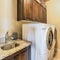 Square Small functional laundry room with washing machine dryer sink and wall cabinet