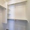 Square Small walk-in closet with corner vertical framed shelves