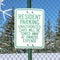 Square Snowflake decor and Resident Parking sign on green mesh wire fence in Park City