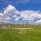 Square Soccer field and baseball field with view of mountain and cloudy blue sky