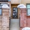 Square Stairs and glass door of residential building with brick fence and balconies