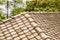 Square stone tile on the roof of a Thai cottage with rounded edges on a blurred background