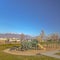 Square Sunny day view of a playground in the middle of a grassy terrain with pathway