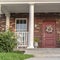 Square Symmetrical house facade with covered porch near sunset