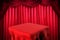 Square table and red curtain background