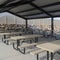 Square Tables with seats inside a gabled roof pavilion in South Jordan City in Utah