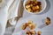 Square toasted pieces of homemade delicious rusk, hardtack, Dryasdust, zwieback in a plate on a white tablecloth
