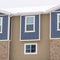 Square Townhome exterior with sliding glass windows brick walls and vertical sidings