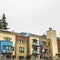 Square Townhomes facade with balconies in Park City Utah against cloudy sky in winter