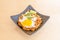 Square tray of fried nasi gore rice with egg and delicious yolk with parsley, piece
