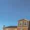 Square Upper storey of townhomes viewed from below against blue sky on a sunny day