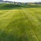 Square Vibrant fairway of a golf course with homes and mountain in the distance