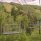 Square Vibrant green summer landscape of trees and mountain beneath chairlifts