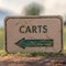 Square Views at a golf course with close up on a white Carts sign with green arrow