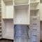 Square Walk in closet interior with shelves hanging rods drawers and metal baskets