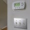 Square Wall mounted air conditioner unlit control and light switches inside a house