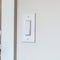 Square Wall mounted electrical rocker light switch with blurry dining room background