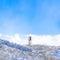 Square Wasatch Mountains landscape with water tank tower on the snowy slope in winter