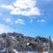 Square Wasatch Mountains winter scenery of houses amid evergreens and snowy terrain