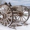 Square Weathered wagon against a scenic landscape blanketed with snow in winter