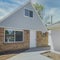 Square Whispy white clouds Guest house exterior with vinyl wood and bricks siding